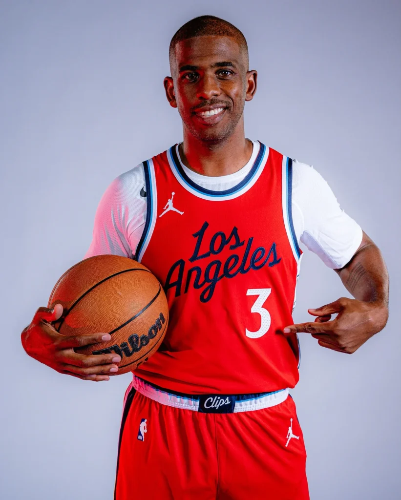 Chris Paul in LA Clippers red jersey number 3 holding basketball amid potential retirement speculation