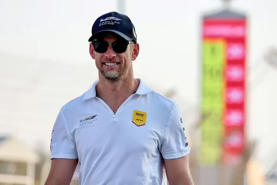 Smiling racing driver in Cadillac Racing uniform and cap illustrating Jenson Button NASCAR retirement career transition and professional motorsports planning