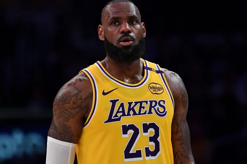 Lebron james retirement timeline discussions surround LeBron James in Lakers gold jersey number 23