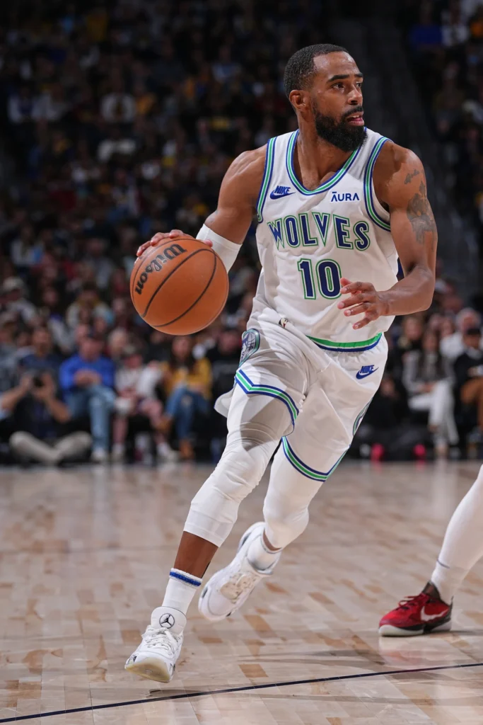 Timberwolves mike conley retirement decision speculation as Mike Conley dribbles in Wolves white jersey number 10