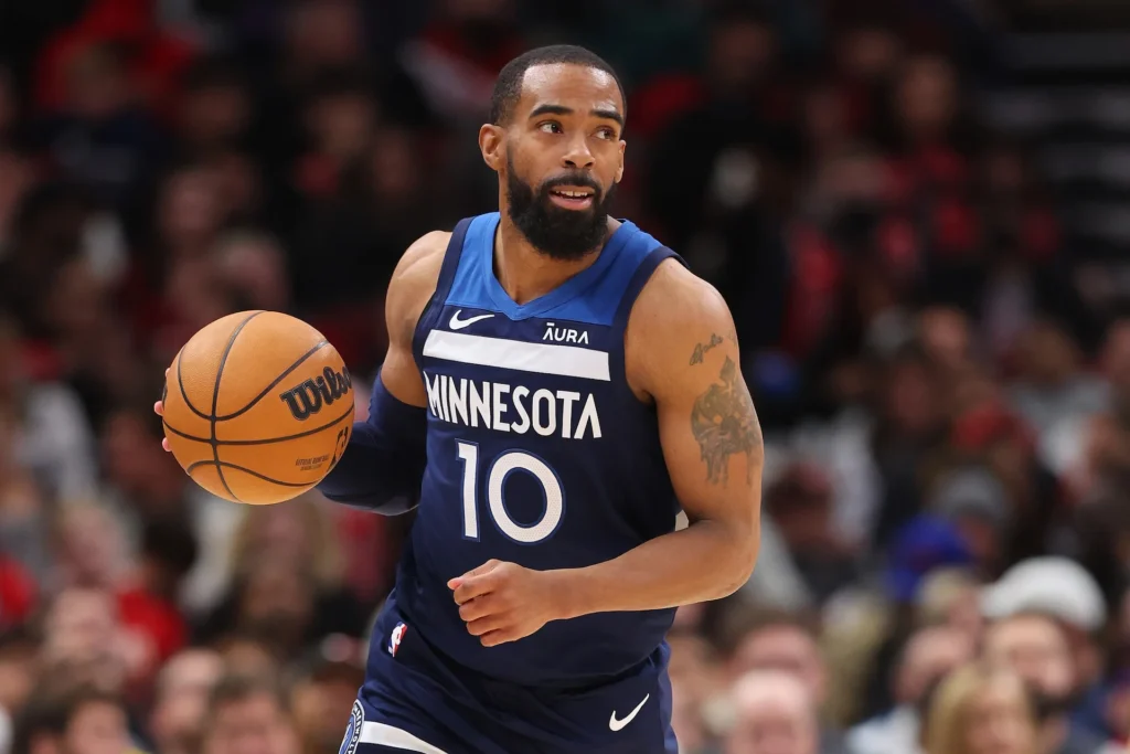 Timberwolves mike conley retirement decision speculation as Mike Conley handles ball in blue Minnesota jersey number 10