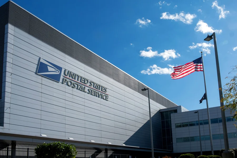 USPS: About 10K employees accept early retirement offer USPS early retirement buyout program at United States Postal Service headquarters building with American flag